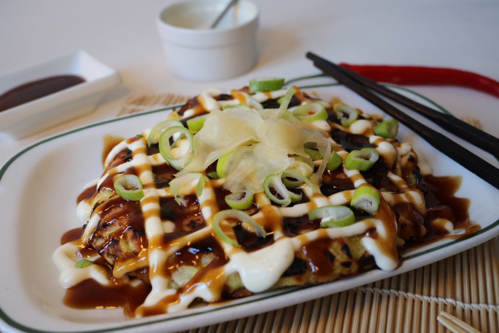 Toppings für Okonomiyaki. Hier mit extra veganem Schinken, der schon mitgebraten wurde. Belegt mit den 2 typischen Saucen, Lauchzwibeln und eingelegtem Ingwer.