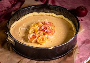 Adding the apple roses to the custard layer