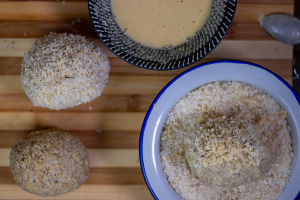 8. The Scotch eggs are first breaded in mixed chickpea flour and then in panko. Then they just need to be fried in hot oil.