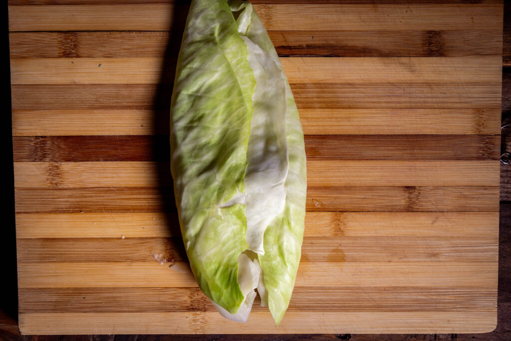 Vegane Kohlrouladen werden gefüllt und gerollt.
