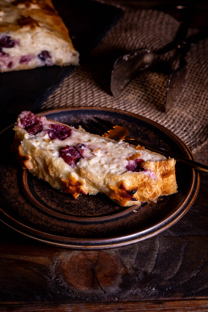 Veganer Quarkstrudel mit Kirschen - ein Stück auf einem Teller