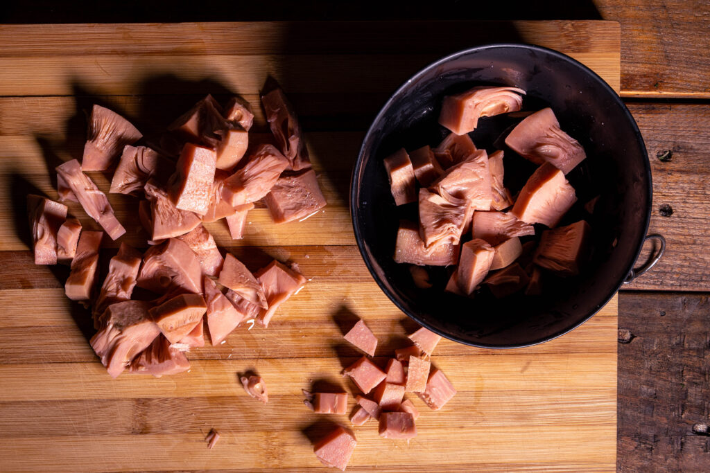 Jackfruit wird auf einem Holzbrett zubereitet.