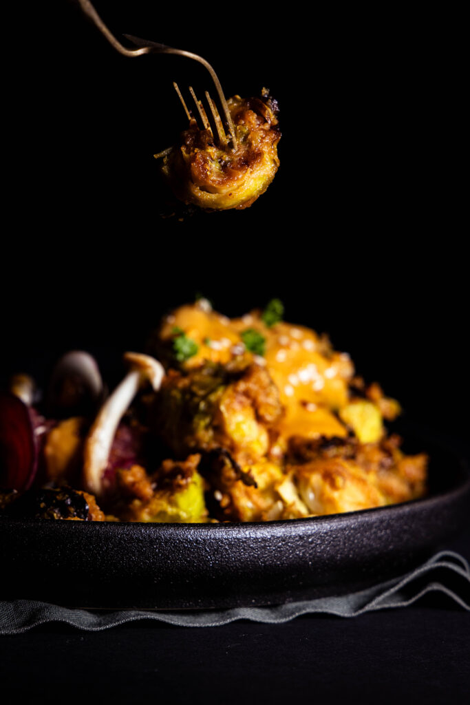 Brussels sprouts in peanut sauce, one on a fork