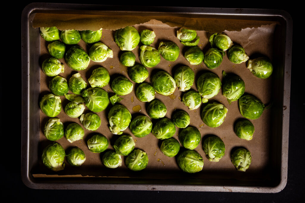 Brussels sprouts arranged on a baking sheet.