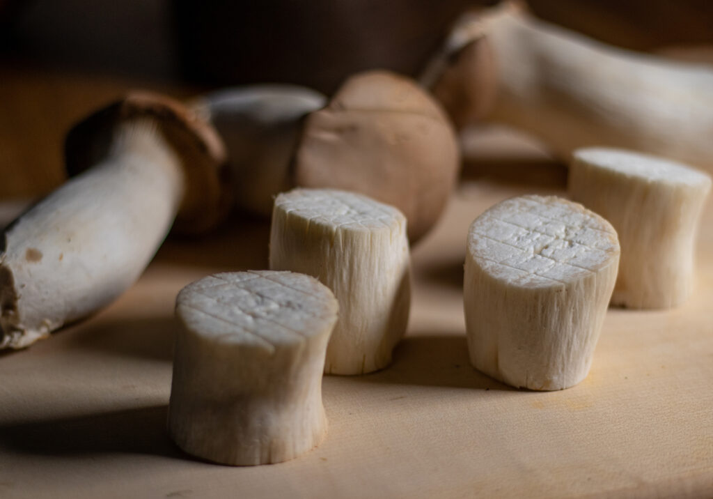 King oyster mushrooms cut into thick slices and scored.