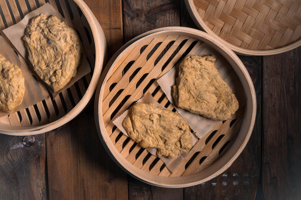 Rohe Sritanschnitzel in einem Dünsteinsatz aus Bambus.