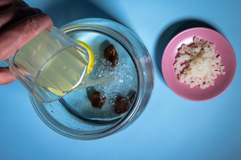Kefir wird als Ansatzflüssigkeit zur Fermentation in ein großes Glas gegossen.