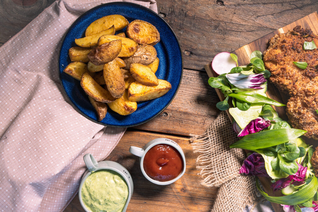 Wedges aus dem Ofen mit Bärlauch-Aioli und Ketchup als Beilage zu veganen Bärlauchschnitzeln
